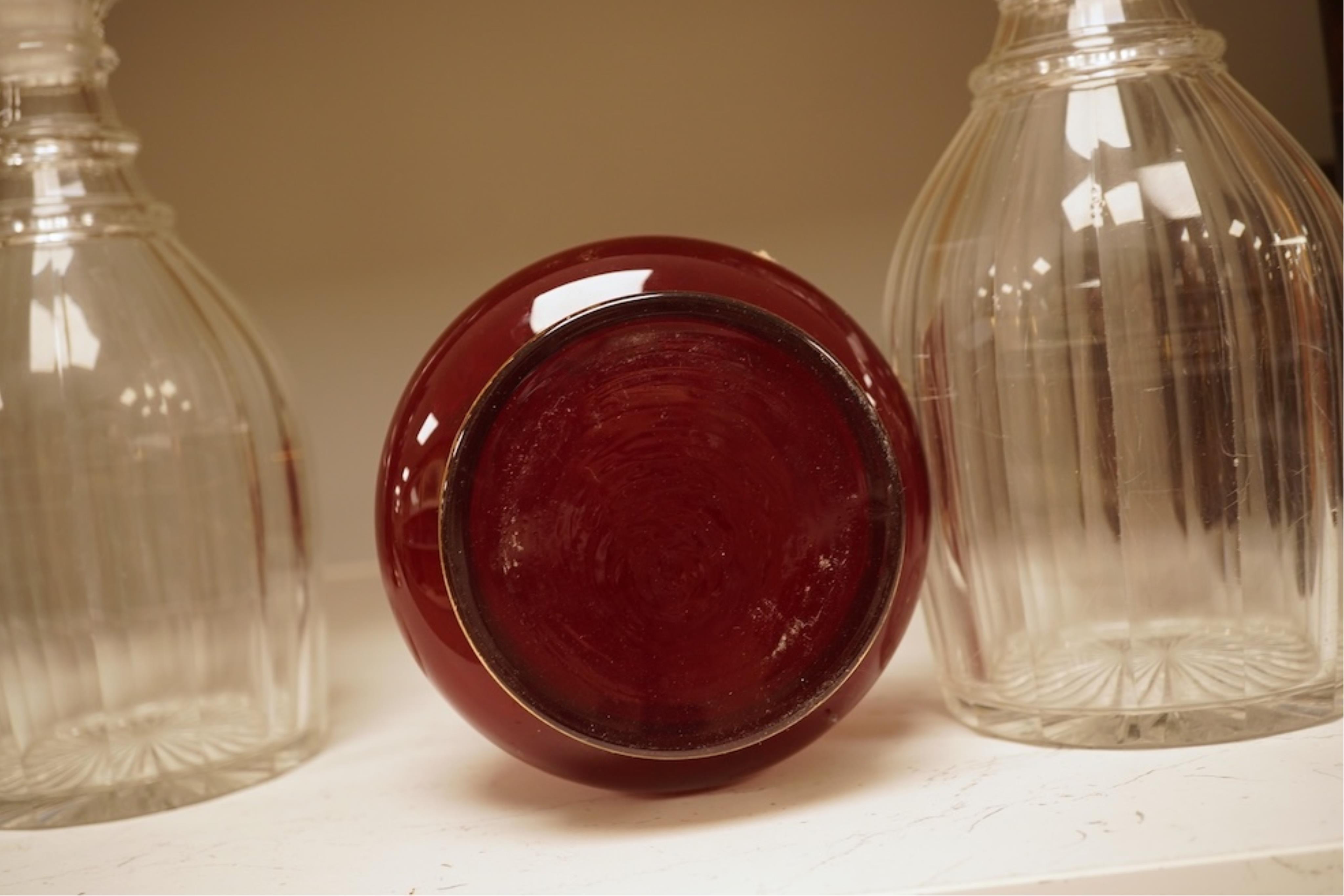 A pair of Victorian glass decanters, later stoppers, and an enamelled ruby glass vase, latter 32cm high
